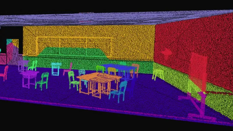 The yellow and red walls of a scanned classroom with its tables and chairs standing on a purple floor, every object separated into its own colour.