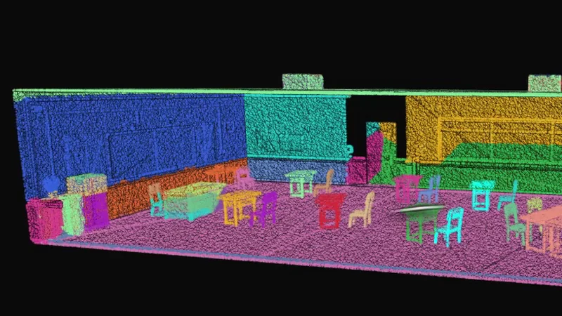 A scanned classroom in which every wall, table and chair has been given its own flat colour automatically, with no one labelling anything by hand.