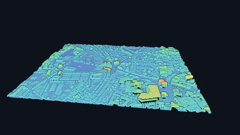 A whole city block scanned from the air as a single tilted tile, streets and rooftops shaded from blue to yellow by their height.