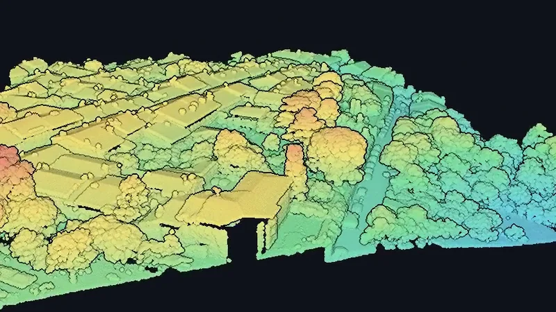A street and its trees captured by lidar and coloured by height, from yellow at ground level through green to pale cyan at the top of the canopy.